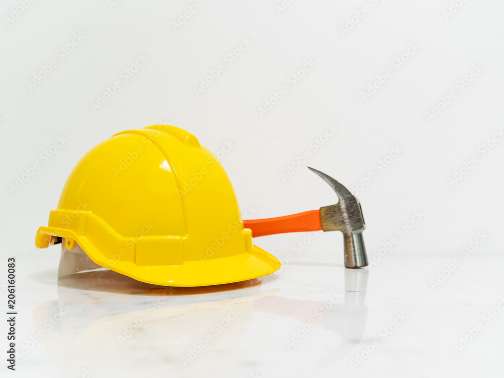 Yellow safety hat and hammer put on white marble counter table desk. Stock  Photo | Adobe Stock