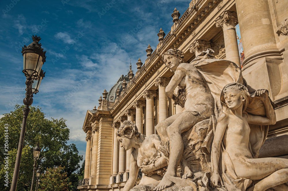 Fototapeta premium Close-up of sculptures decorating the entrance gate of the Petit Palais on sunny day in Paris. Known as the “City of Light”, is one of the most impressive world’s cultural center. Northern France.