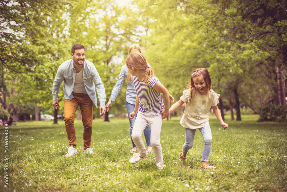 Family playing at park.