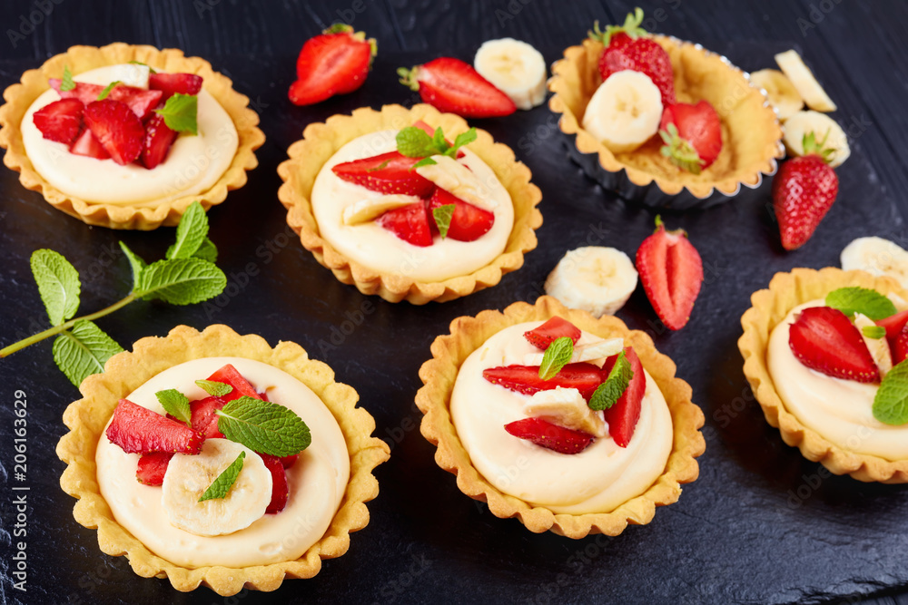 tartlets with strawberries, banana, mint, close-up tartlets with strawberries, banana, mint, close-up