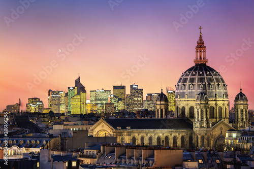 The Saint Augustin church and parisian houses with modern skyscrapers of business La Defense district in the background, France