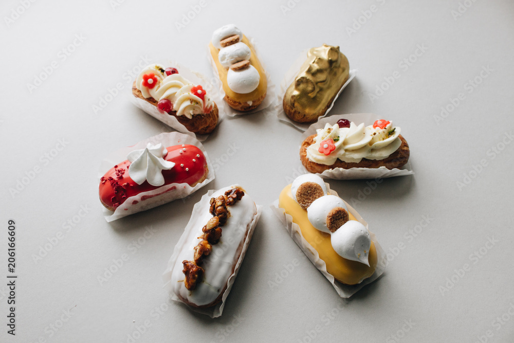 Assorted delicious sweets on grey background Assorted delicious sweets on grey background