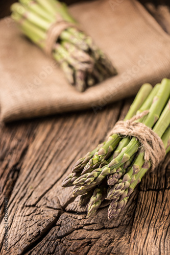 Bunch of fresh asparagus on rustic oak table