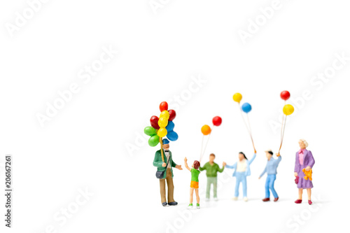 Miniature people : Happy family holding balloon on white background