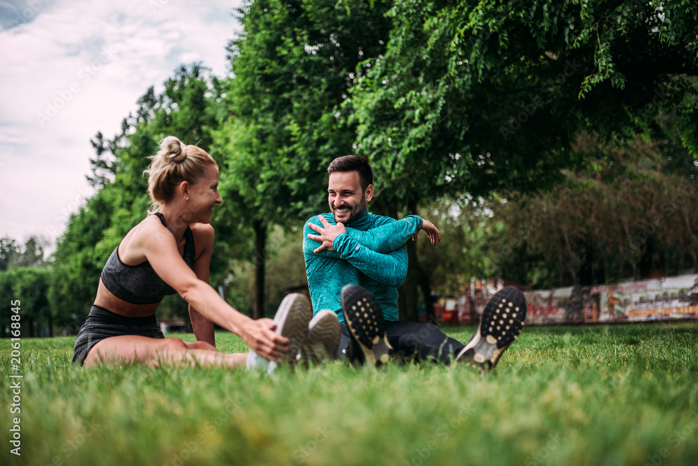 Couple warming up before run in the park. Couple warming up before run in the park.