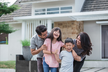 family in front of their new house