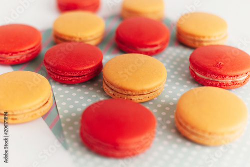 stylish red and yellow macaroons stacked on modern craft paper, creative view. space for text. catering for celebrations and holidays concept
