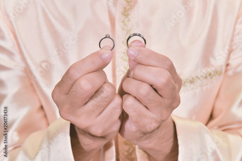 Man hand holding diamond ringsn for wedding ceremony.