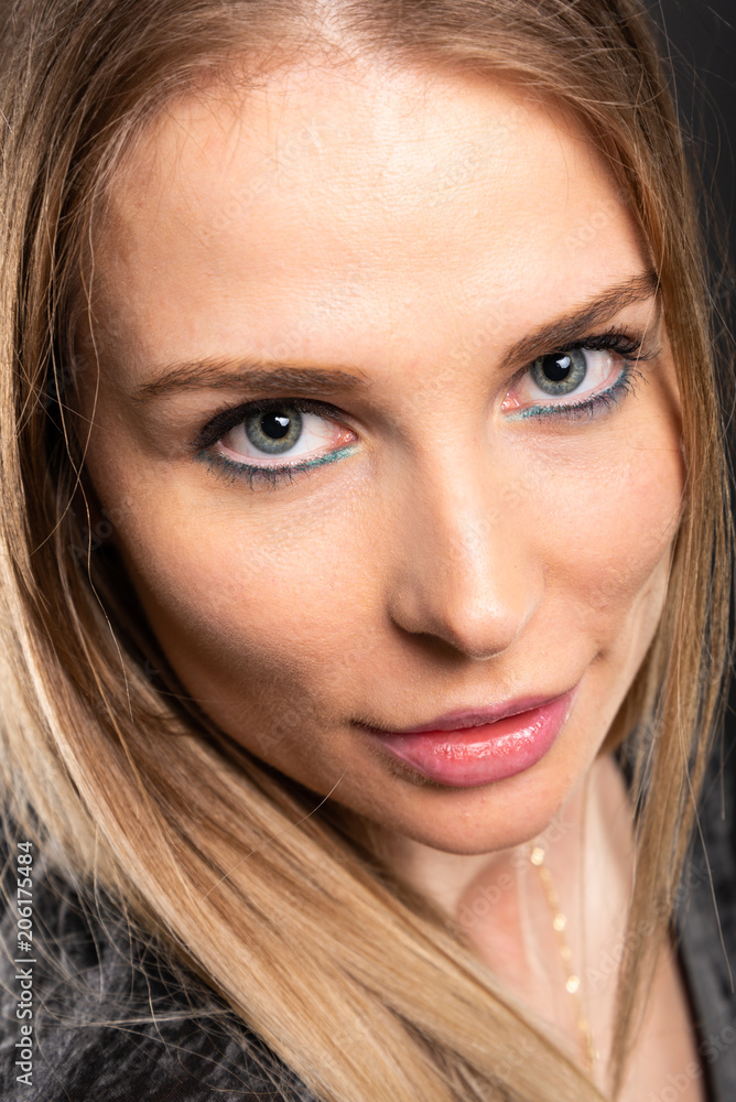 Close-up of beautiful female model posing with colorful make-up. Close-up of beautiful female model posing with colorful make-up.