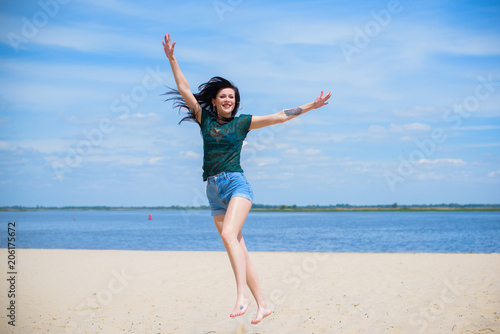 Woman Jumping on the Beach Having Fun, Summer vacation holiday Lifestyle. Happy women jumping freedom on white sand. 