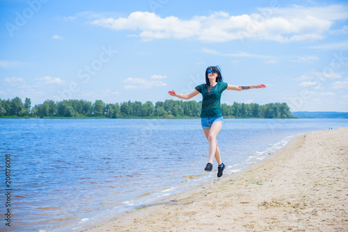 Woman Jumping on the Beach Having Fun, Summer vacation holiday Lifestyle. Happy women jumping freedom on white sand.  © T.Den_Team