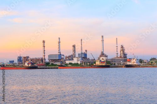 Oil refinery at the river in sunset time / Big Factory in sunrise time