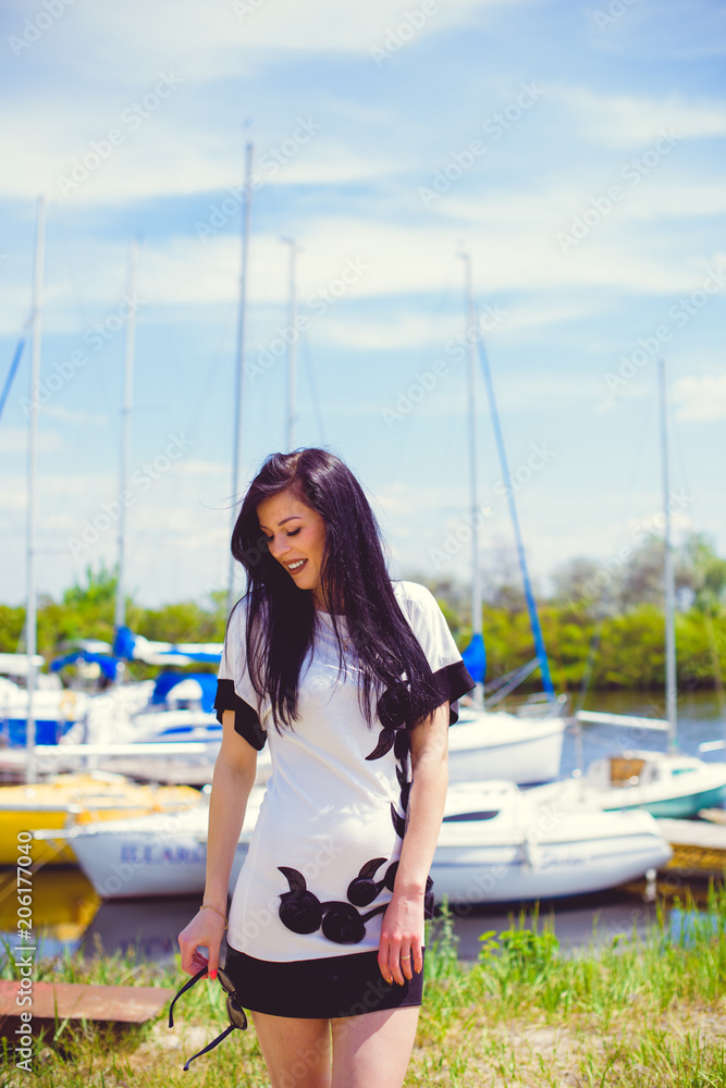 American stylish fashionable woman rest in yacht club, relax on a nature enjoy the life