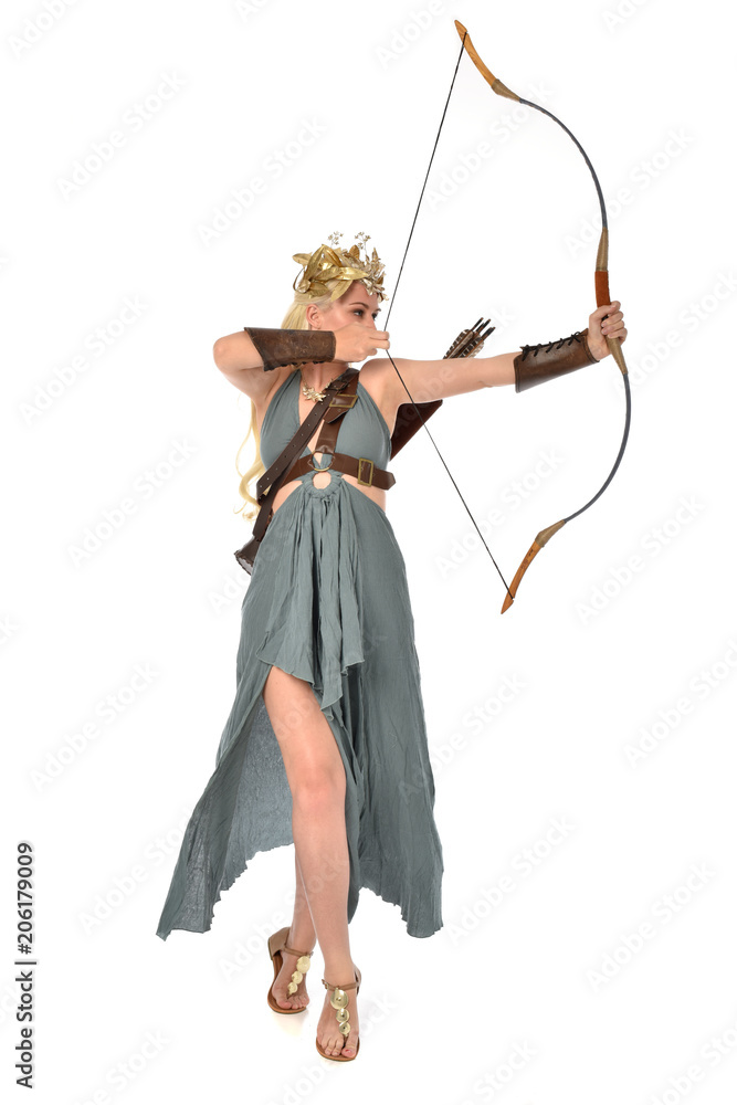 full length portrait of pretty blonde lady wearing fantasy toga gown, and holding a bow and arrow. standing pose on white background. full length portrait of pretty blonde lady wearing fantasy toga gown, and holding a bow and arrow. standing pose on white background.