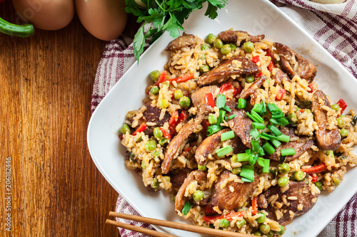 Fried rice with chicken and vegetables served on a plate