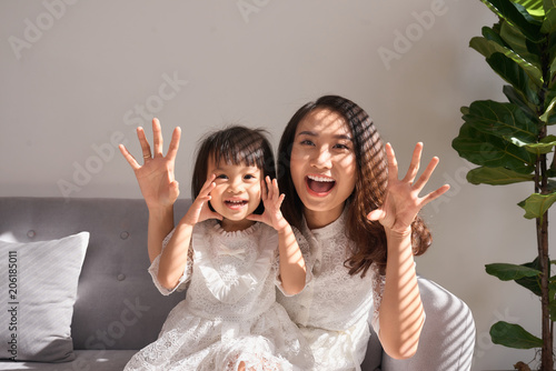 Happy young mother with daughter at home photo