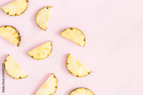 Pineapples on pastel pink background. Summer concept. Flat lay, top view, copy space