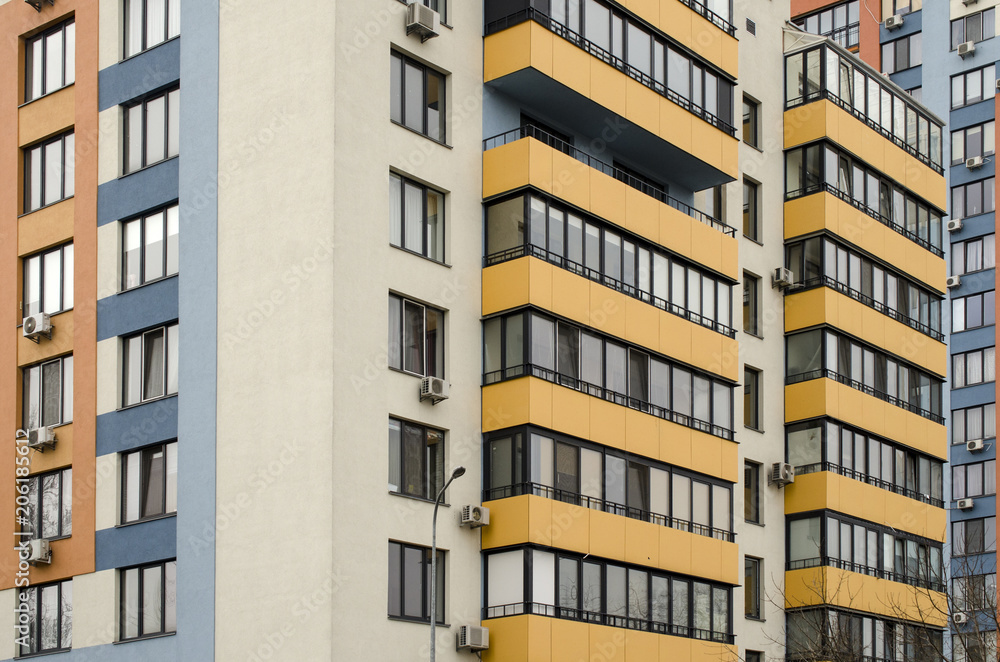 facade of a multi-storey building with yellow balconies