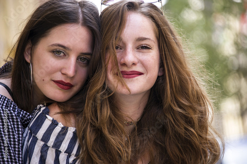 Two lovely girls having fun on the street. Bff conception. 