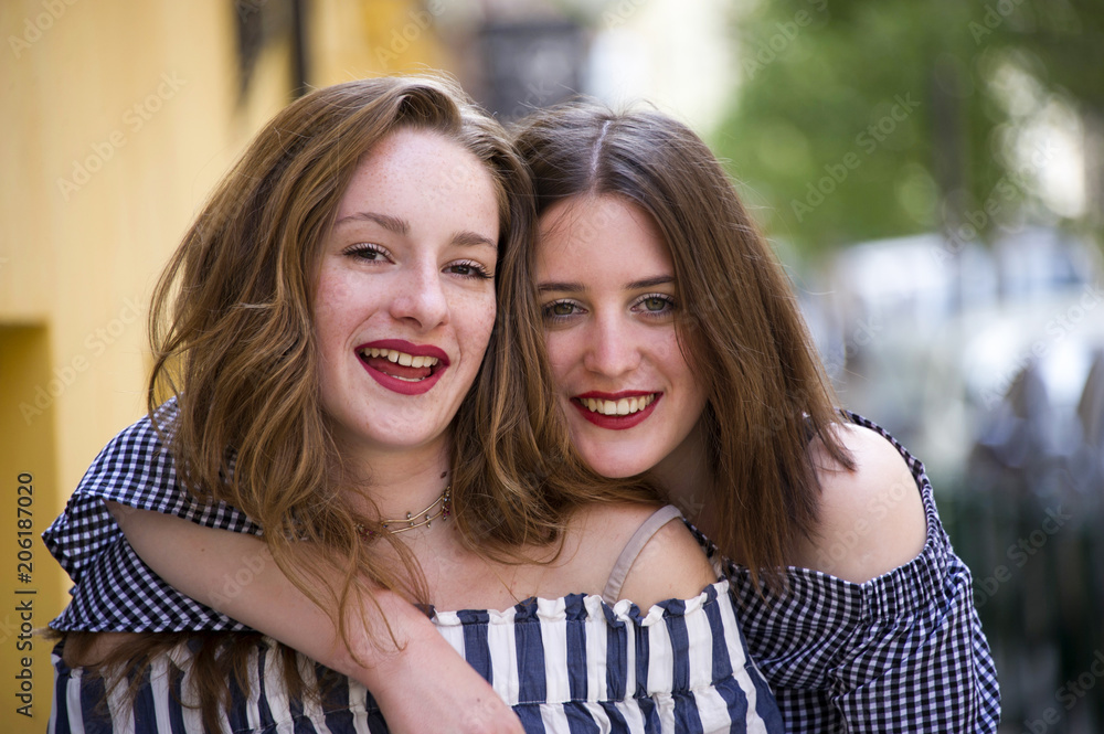 Obraz premium Two lovely girls having fun on the street. Bff conception.
