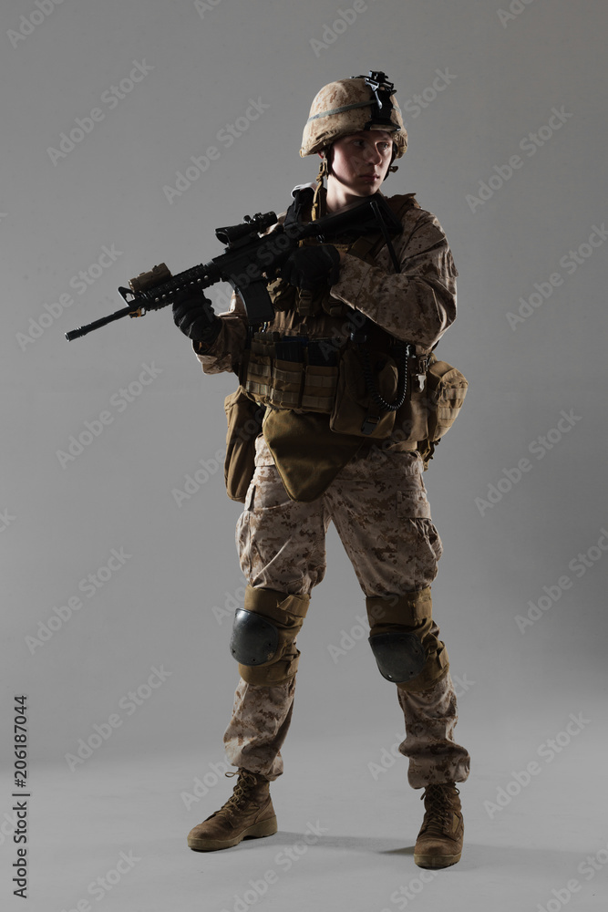 Soldier in camouflage holding rifle Soldier in camouflage holding rifle