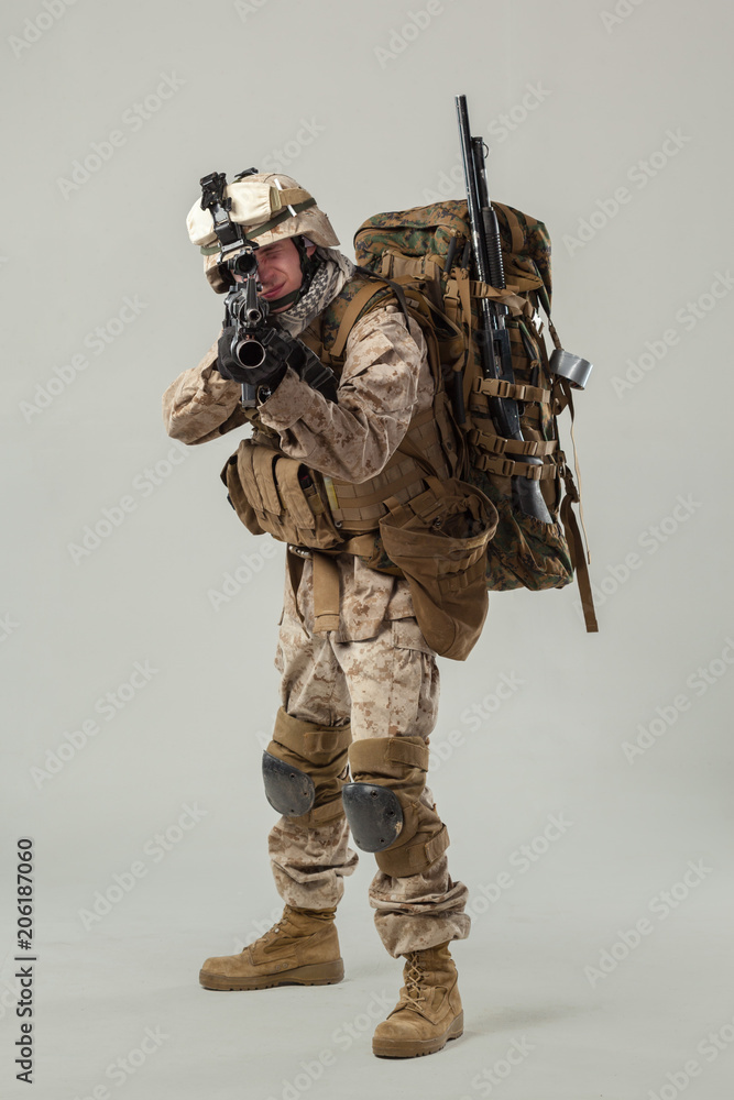 Soldier in camouflage holding rifle Soldier in camouflage holding rifle