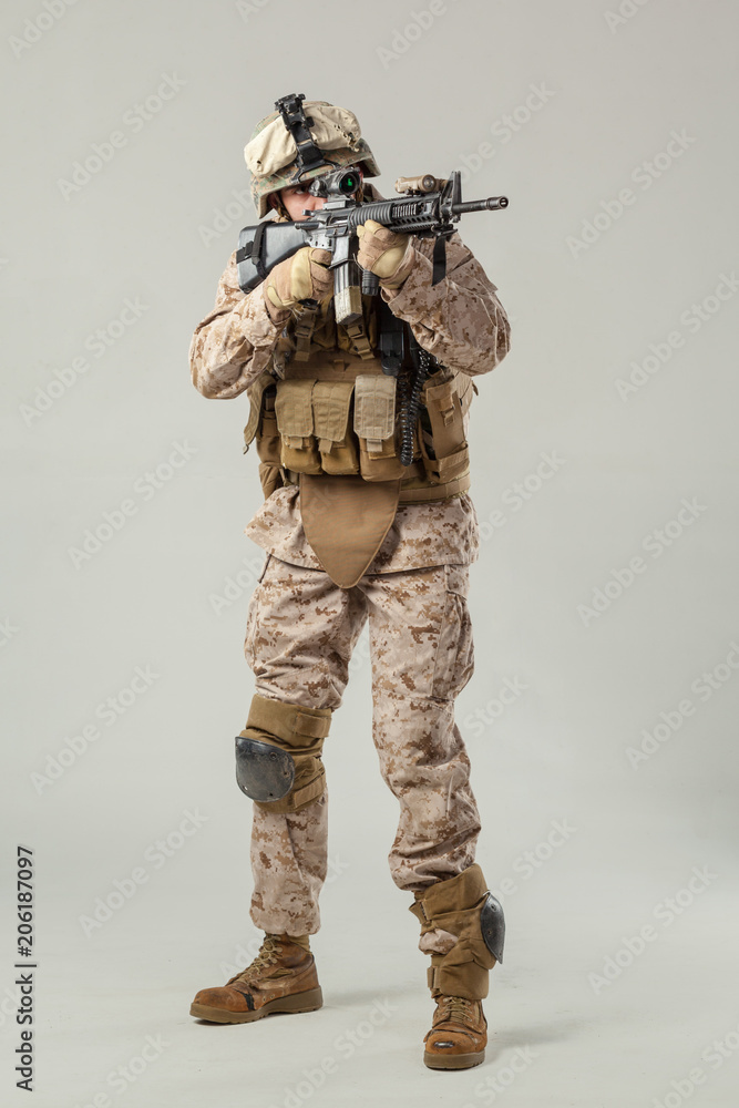 Soldier in camouflage holding rifle Soldier in camouflage holding rifle
