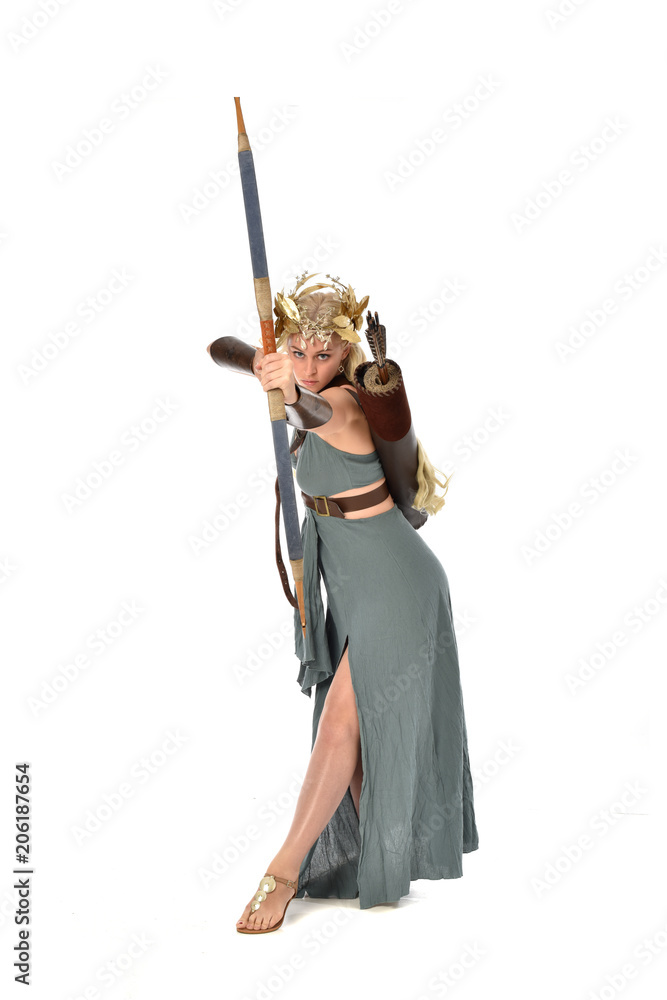 full length portrait of pretty blonde lady wearing fantasy toga gown, and holding a bow and arrow. standing pose on white background. full length portrait of pretty blonde lady wearing fantasy toga gown, and holding a bow and arrow. standing pose on white background.