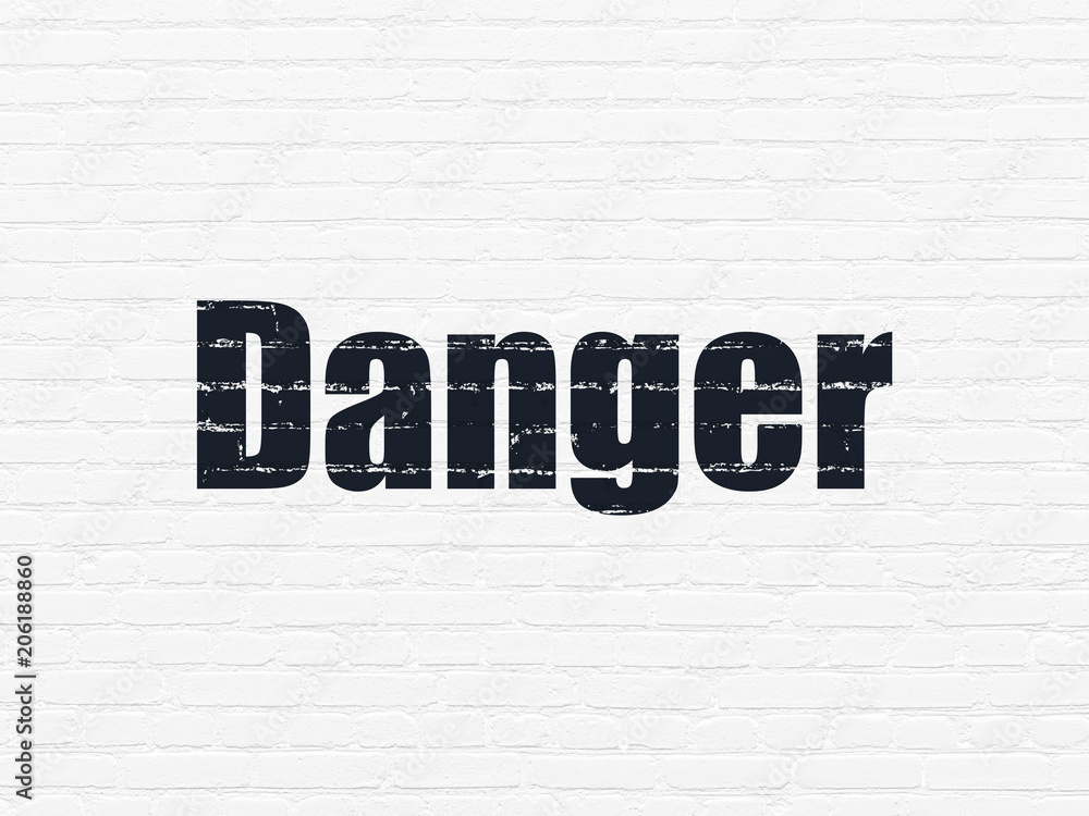 Safety concept: Painted black text Danger on White Brick wall background