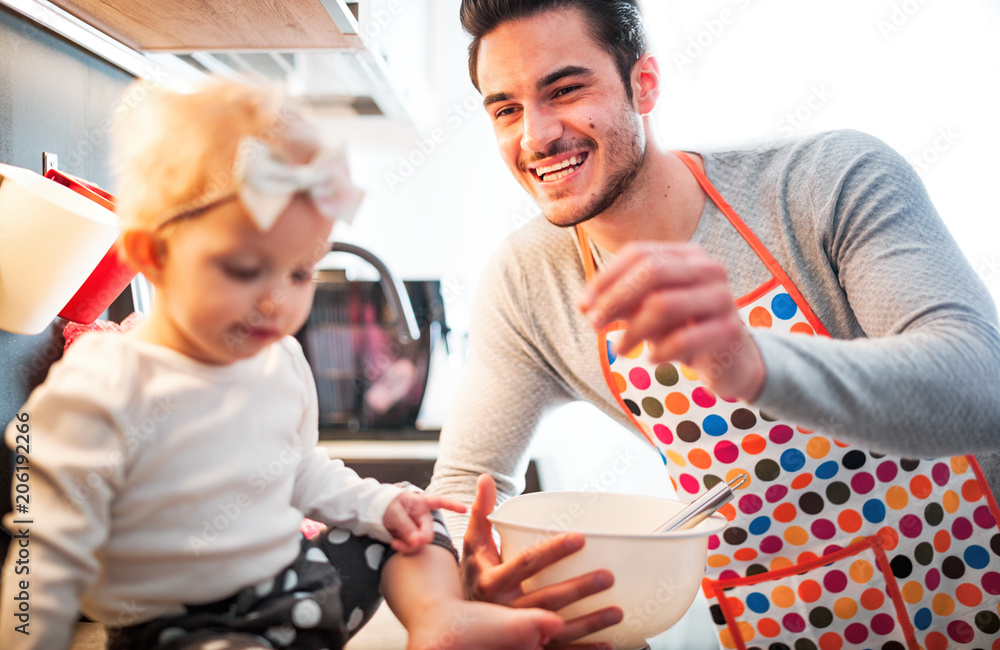 Little child girl in the kitchen having fun with her dad, family lifestyle Little child girl in the kitchen having fun with her dad, family lifestyle