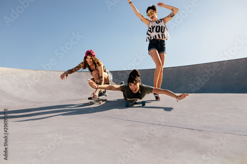 Group of women playing with skateboards