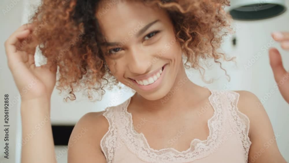 Portrait of young afro american woman at home. Portrait of young afro american woman at home.