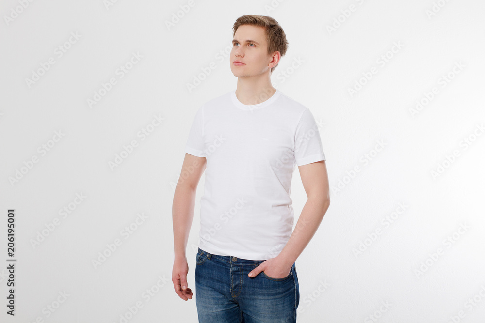 Front view. Young man wearing blank white t-shirt isolated on white background. Copy space. Place for advertisement Front view. Young man wearing blank white t-shirt isolated on white background. Copy space. Place for advertisement