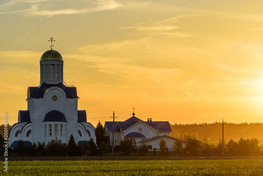 church in the field at sunset