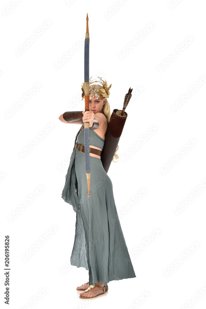 full length portrait of pretty blonde lady wearing fantasy toga gown, and holding a bow and arrow. standing pose on white background. full length portrait of pretty blonde lady wearing fantasy toga gown, and holding a bow and arrow. standing pose on white background.