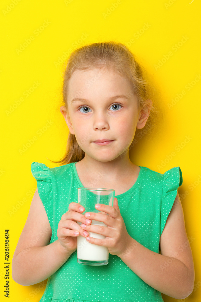 Cute kid drinking milk on blue background Cute kid drinking milk on blue background