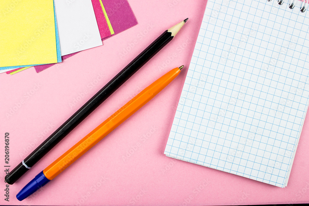 Pen and pencil. Notepad and color papers. Empty space for text and design. Office tools concept Pen and pencil. Notepad and color papers. Empty space for text and design. Office tools concept