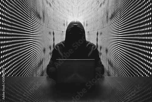 Anonymous hacker in front of his computer