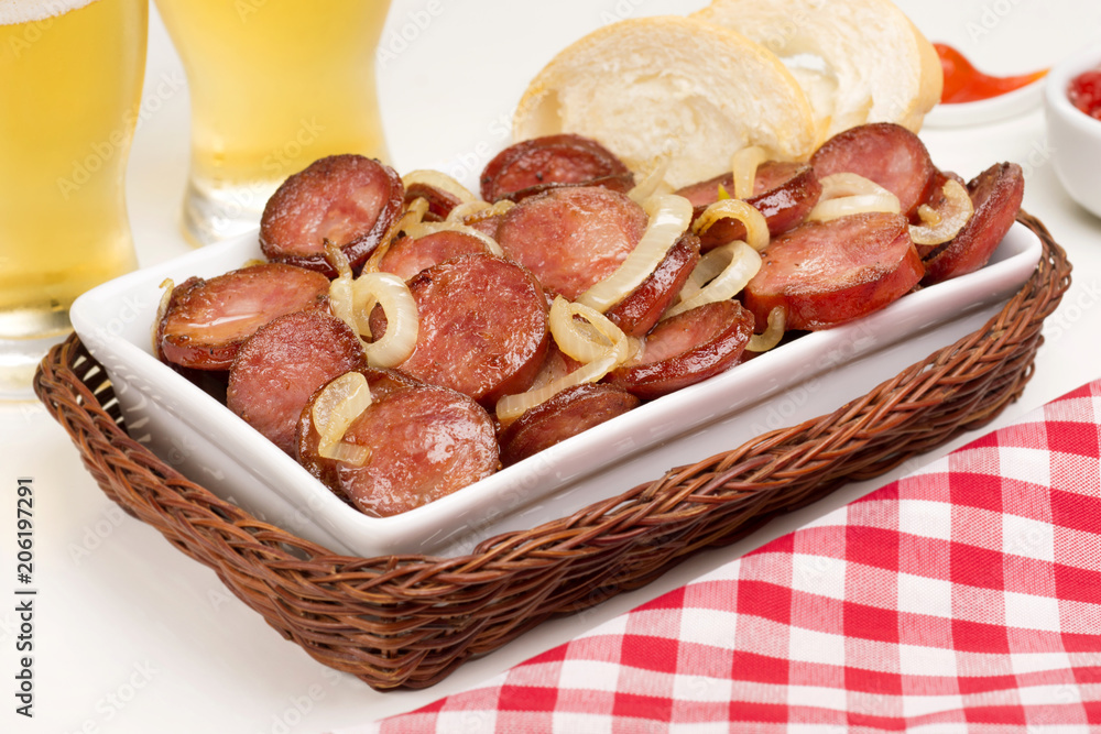 Sliced and fried Calabrese sausage in a pub table 