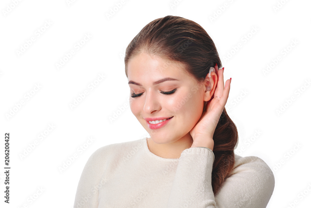 Cute girl with hearing aid looks aside and smile. At isolated white background. Cute girl with hearing aid looks aside and smile. At isolated white background.