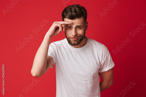 Confused young handsome man looking camera.