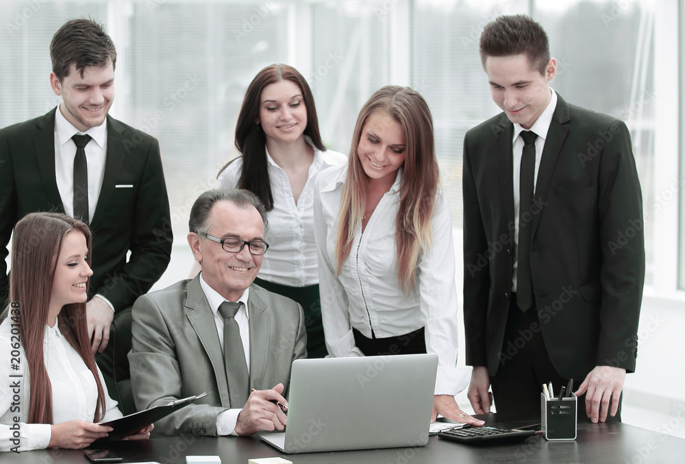 Director and business team looking at laptop screen. Director and business team looking at laptop screen.