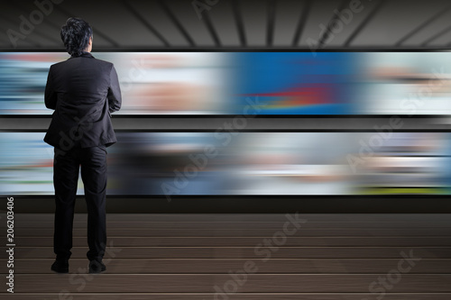 Businessman looking at the TV screen