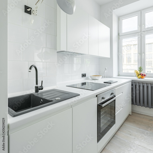 Fototapeta Naklejka Na Ścianę i Meble -  White kitchen with sink