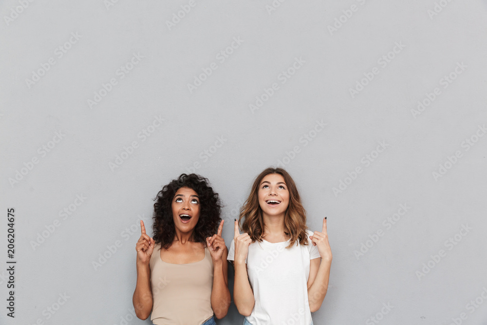 Portrait of two cheerful young women - obrazy, fototapety, plakaty 
