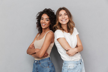 Portrait of two cheerful young women standing together