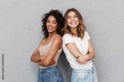 Portrait of two cheerful young women standing together