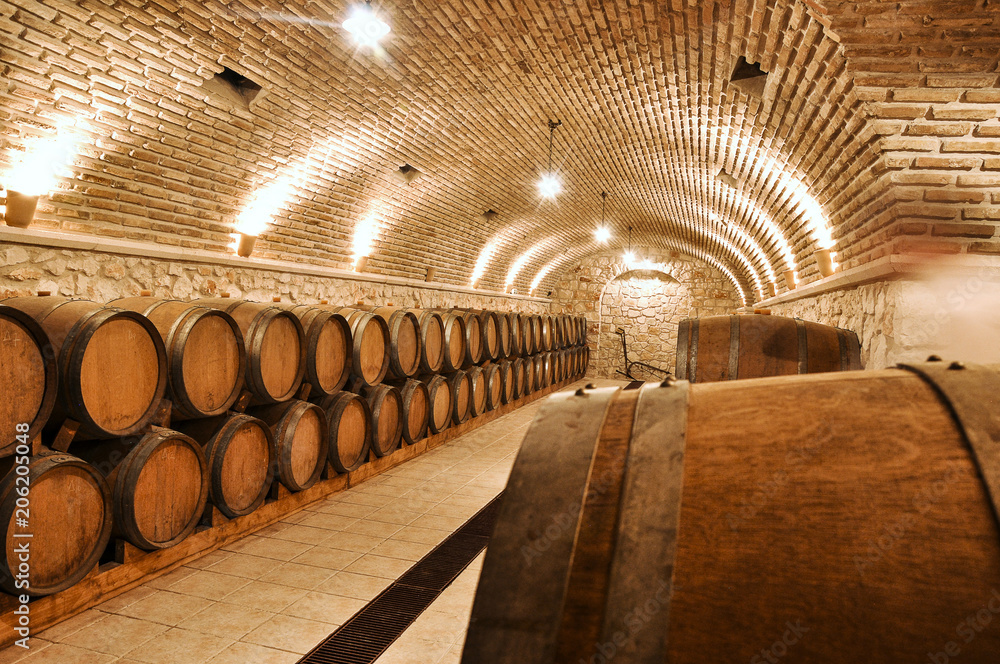Wine barrels in the old basement of a winery storage. Cellar of