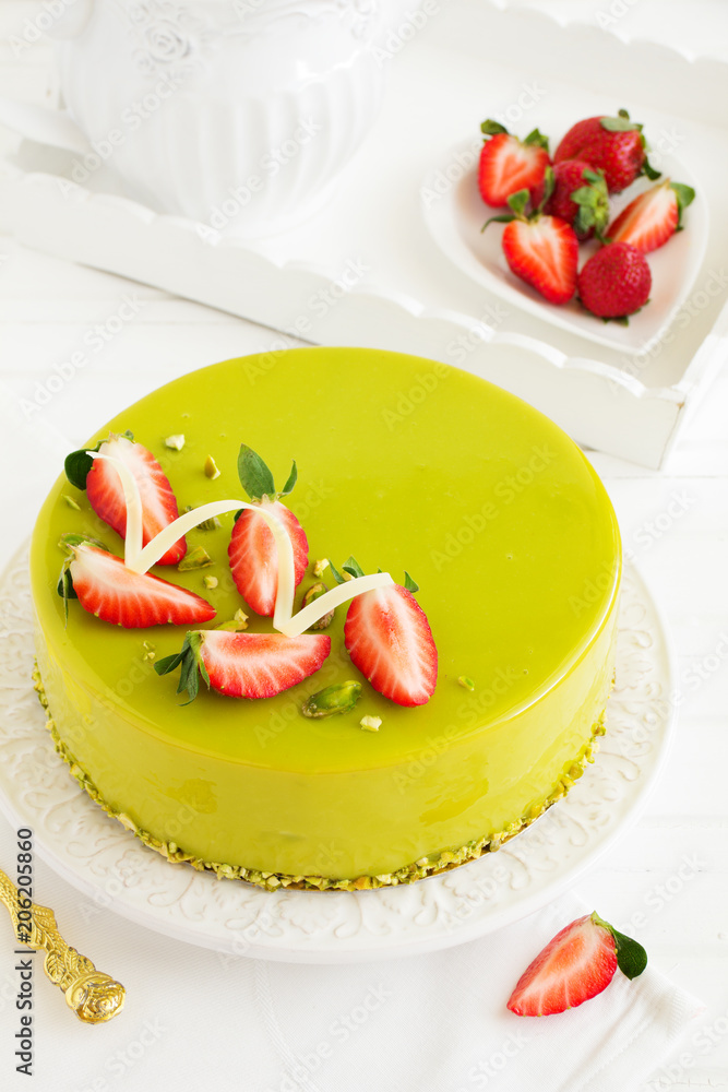 Delicious strawberry-pistachio mousse cake with a smooth glaze. Delicious strawberry-pistachio mousse cake with a smooth glaze.