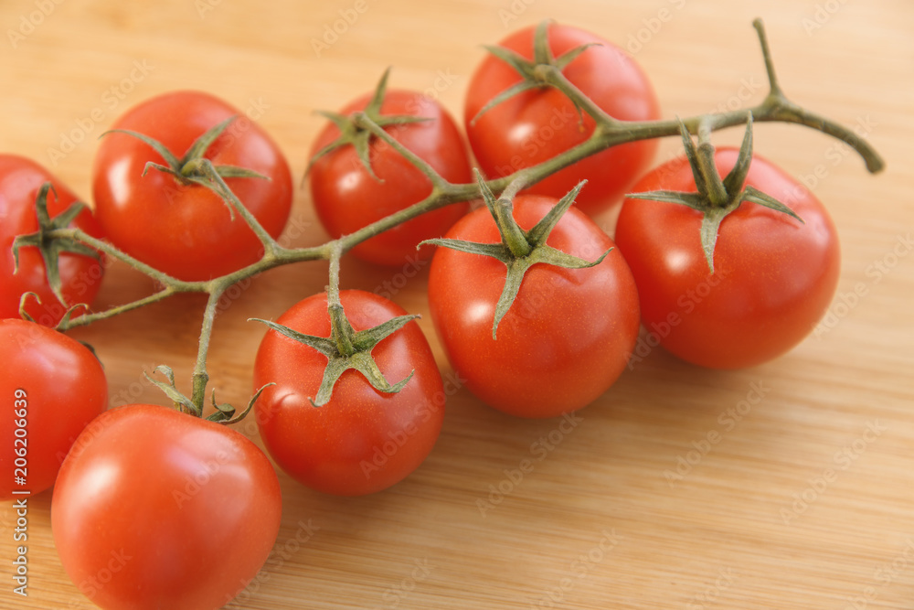 Natural-looking tomatoes on wooden background. Selective focus. Natural-looking tomatoes on wooden background. Selective focus.